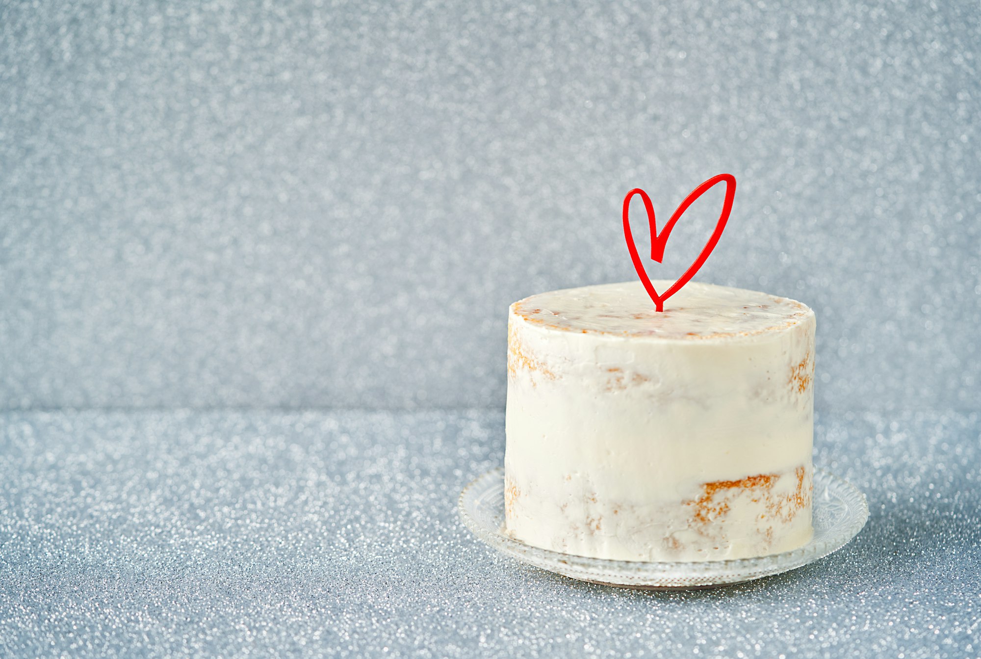 White Cake decorated with heart cake topper,